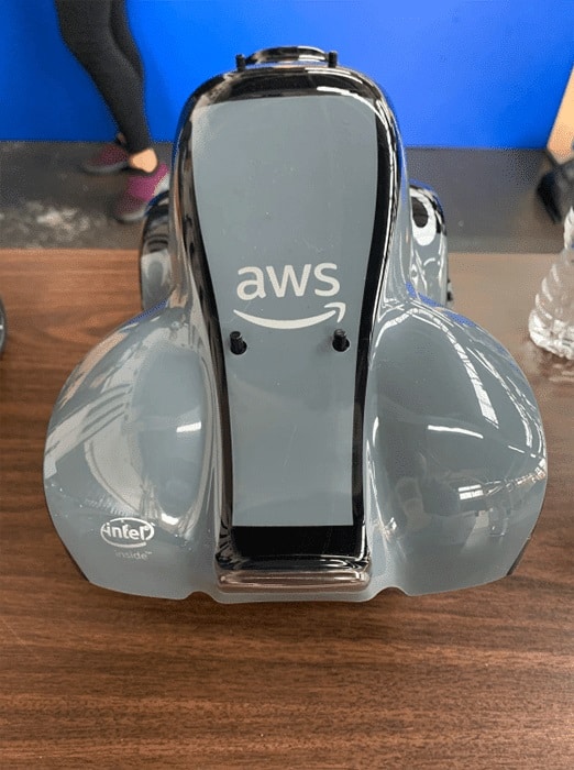 Close-up view of an AWS DeepRacer model car showcasing the AWS logo and Intel sponsorship.