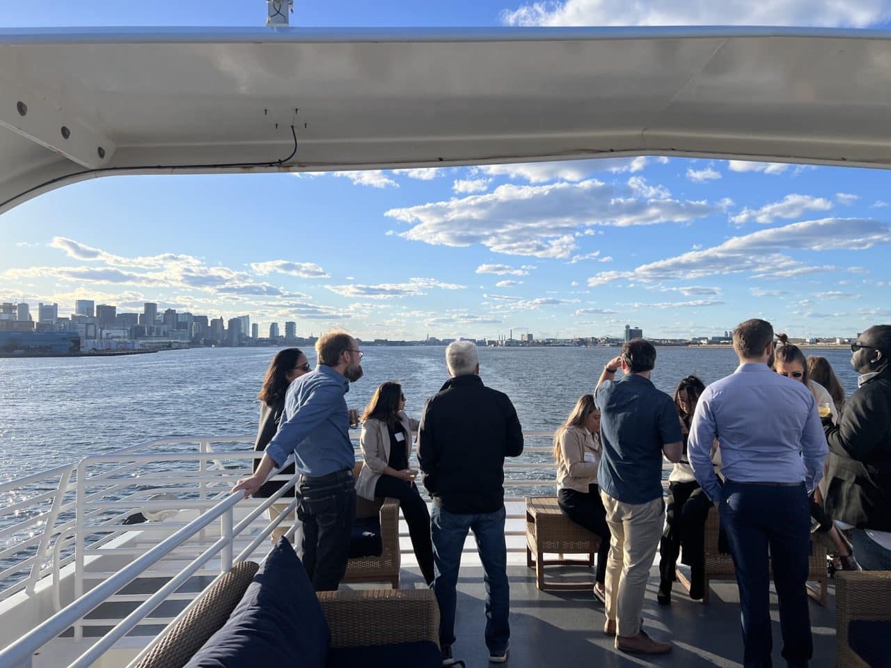 Attendees networking on the top deck before sunset at the Bio-IT Harbor Cruise Networking Event.