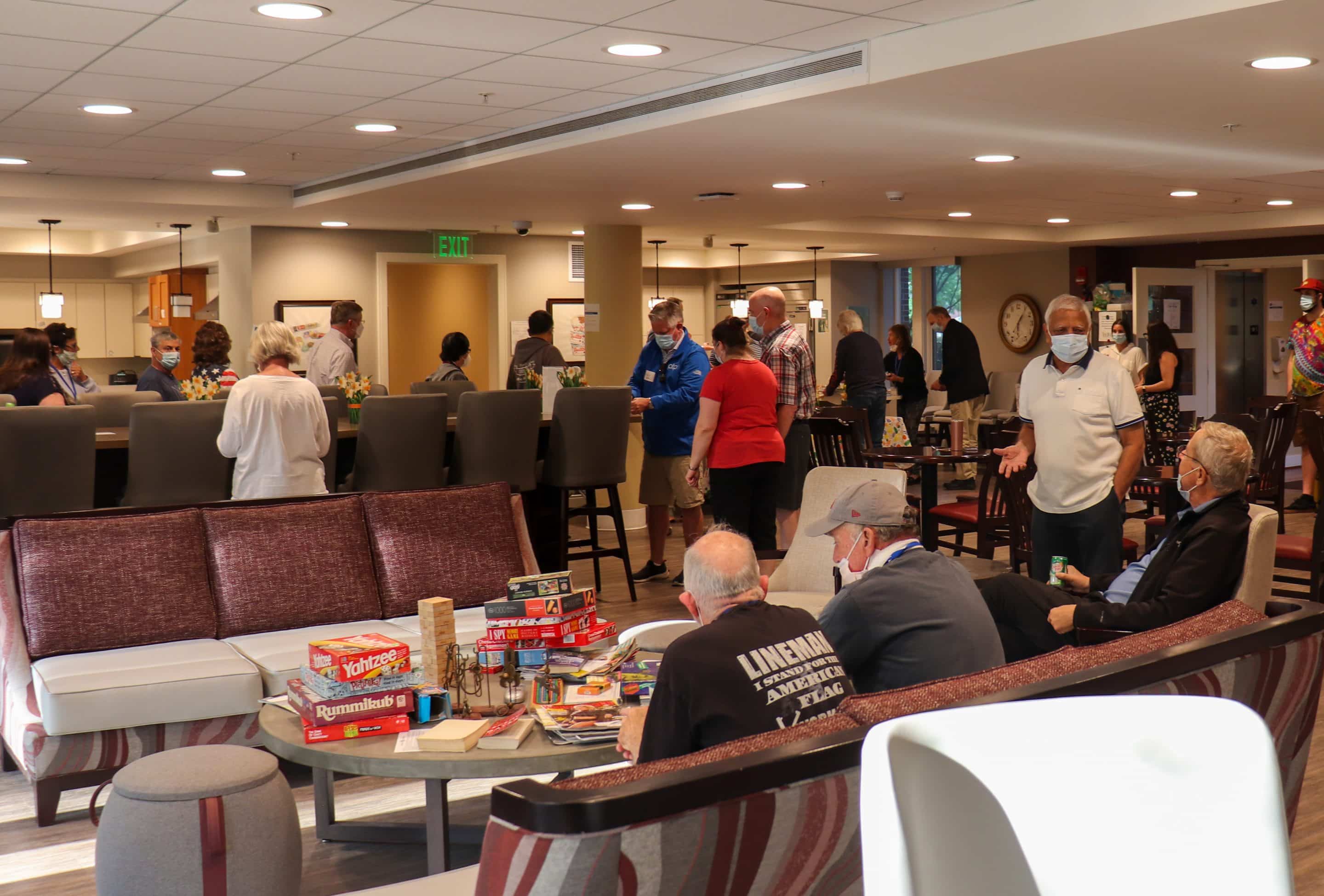 Candid shot of the PTP Gives Back team mingling with guests at the American Cancer Society Hope Lodge in Boston.