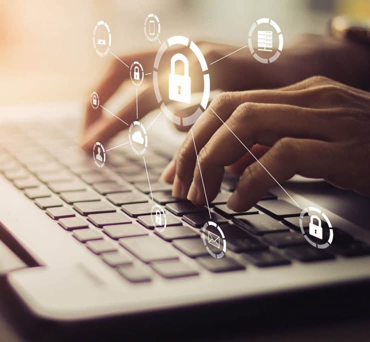 Hands typing on a laptop keyboard with security icons overlaid, including padlocks and network symbols.